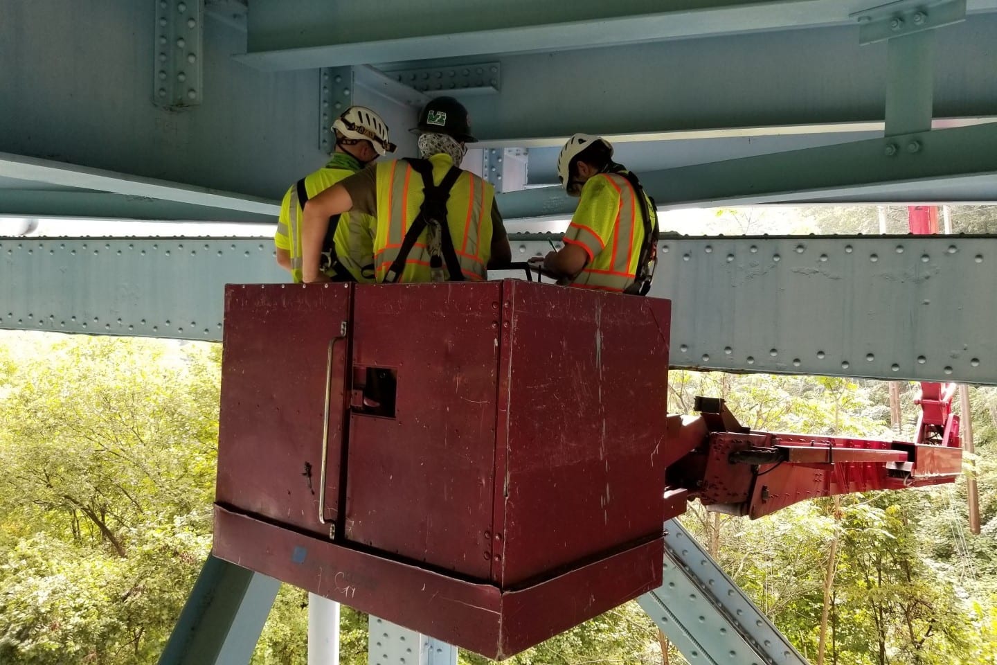 Three Bridge Engineers Working Beneath a Bridge